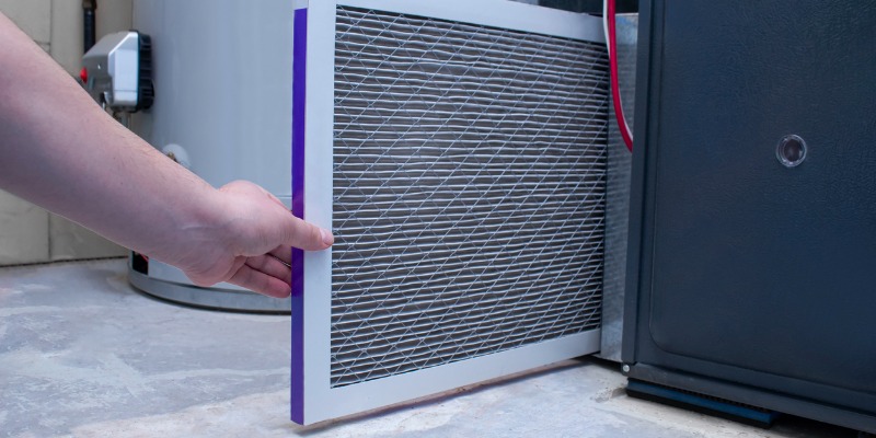 Person Changing An Air Filter On A High Efficiency Furnace Picture Id1308363658